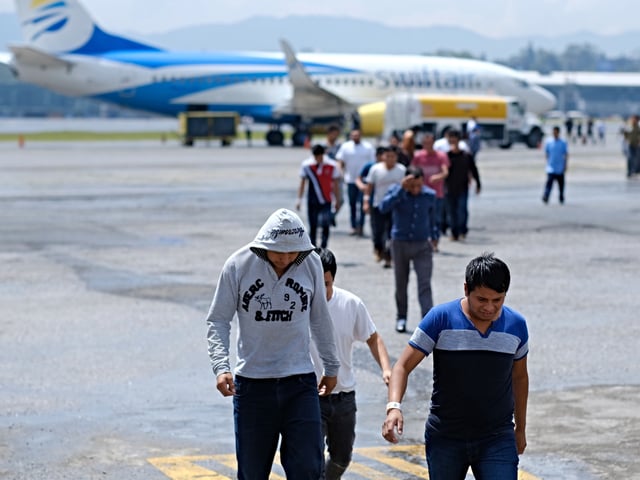 GUATEMALA CITY, GUATEMALA - AUGUST 23: Guatemalans walk off a plane during the arrival of a flight coming from Mesa, Arizona with deported Guatemalan Citizens at La Aurora International Airport on August 23, 2019 in Guatemala City, Guatemala. Under a new policy, ICE has expedited removal procedures for many Guatemalan families and adults arriving to the U.S.-Mexico border. The more streamlined approach replicates how DHS currently works with immigrant removals to Mexico, according to DHS. (Photo by Josue Decavele #792748#51B ED/Getty Images)