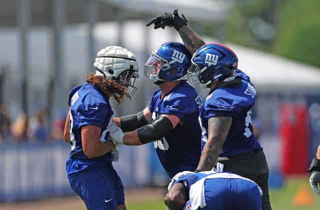 EAST RUTHERFORD, NEW JERSEY - JULY 24: Greg Dulcich #89  and Aaron Stinnie #64 of the New York Giants react during training camp at Quest Diagnostics Training Center on July 24, 2025 in East Rutherford, New Jersey. (Photo by Ishika Samant/Getty Images)