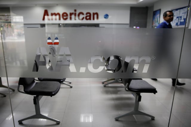 Corporate logos of American Airlines are seen at their office in Caracas, Venezuela March 15, 2019. REUTERS/Carlos Garcia Rawlins