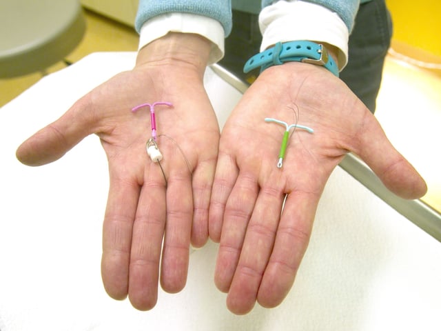 Dr. Susan Gorman displays the Skyla IUD, left, and the Mirena IUD, at High Lakes Gynecology in Redmond, Ore., Jan. 14, 2015. (Andy Tullis/The Bulletin via AP)