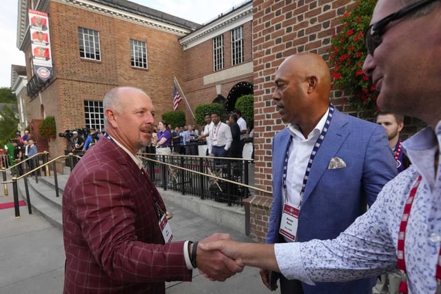 Former Houston Astros Hall of Fame closer Billy Wagner, left, shakes hands with Ferrum College coach Darren Hodges after introducing him to Hall of Fame closer Mariano Rivera after the Hall of Fame Legends Parade in Cooperstown, N.Y., Saturday, July 26, 2025.