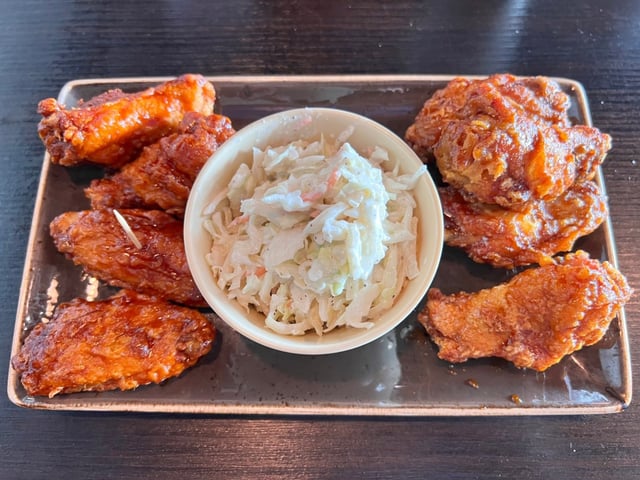 A lunch combo at Bonchon includes soy garlic and spicy chicken wings and a side of coleslaw. (2022 photo by Fielding Buck, The Press-Enterprise/SCNG)