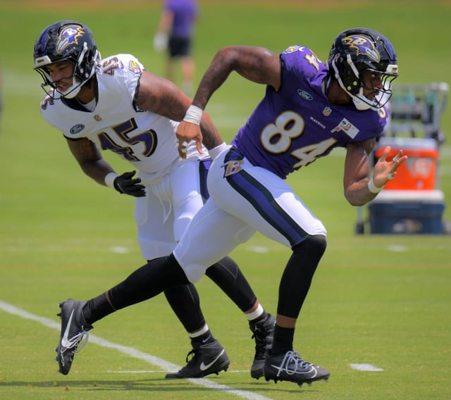 Baltimore Ravens outside linebacker Mike Green and tight end Zaire Mitchell-Paden pass each other during training camp. (Karl Merton Ferron/Staff)