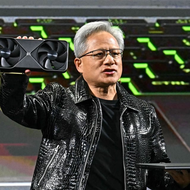 Nvidia CEO Jensen Huang holds a Blackwell GeForce RTX 50 Series GPU (L) and a RTX 5000 laptop as he delivers a keynote address at the Consumer Electronics Show (CES) in Las Vegas, Nevada on January 6, 2025.