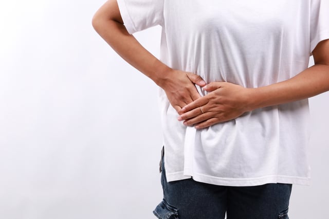 Man holding stomach with pain at top right hand side.