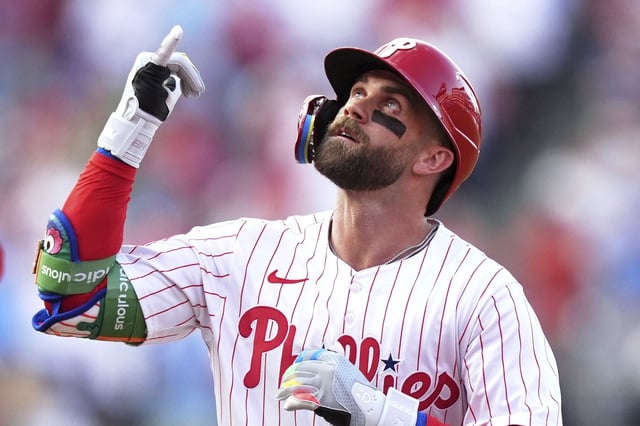 Philadelphia Phillies' Bryce Harper reacts after hitting a home run against Boston Red Sox pitcher Lucas Giolito during the first inning of a baseball game Wednesday, July 23, 2025, in Philadelphia. (AP Photo/Matt Slocum)