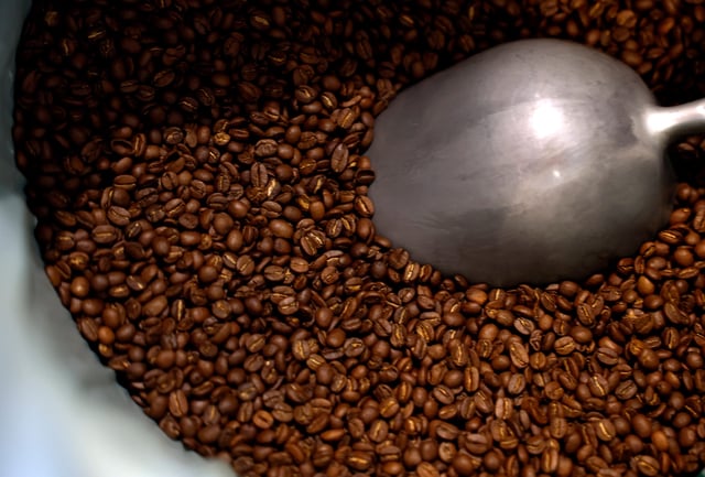 Freshly roasted coffee beans are seen in a barrel at Sightglass Coffee on April 07, 2025 in San Francisco, California.