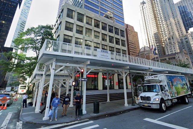 Pedestrians walk past 345 Park Avenue in New York City.
