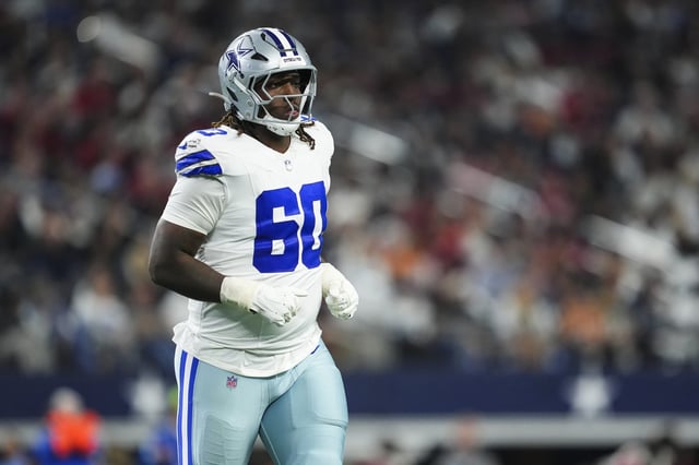 Tyler Guyton #60 of the Dallas Cowboys looks on from the field during an NFL football game against the Tampa Bay Buccaneers at AT&amp;T Stadium on December 22, 2024 in Arlington, Texas.Cooper Neill/Getty Images