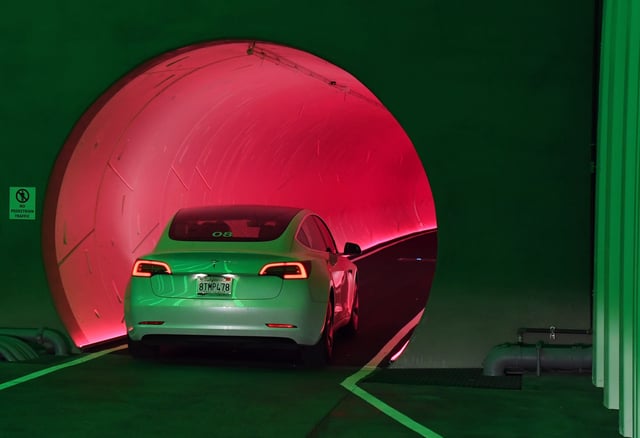 A Tesla car drives through a tunnel in the Central Station during a media preview of the Las Vegas Convention Center Loop on April 9, 2021 in Las Vegas, Nevada.