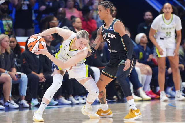 Dallas Wings guard Paige Bueckers (5) keeps the ball from New York Liberty guard Natasha Cloud (9) during the first half of a WNBA basketball game in Arlington, Texas, Monday, July 28, 2025. (AP Photo/LM Otero)