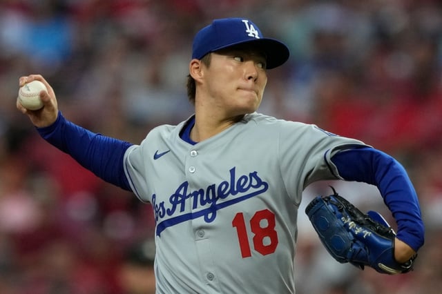 Dodgers starting pitcher Yoshinobu Yamamoto throws to the plate during the first inning of their game against the Cincinnati Reds on Monday night in Cincinnati. (AP Photo/Carolyn Kaster)
