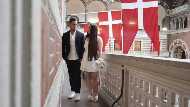 Newlyweds Magdalena Kujawińska, right, from Poland and Heinner Valenzuela from Colombia pose for photos at the Copenhagen City Hall in Copenhagen, Denmark. Wednesday 9 July 2025. (AP Photo/James Brooks)