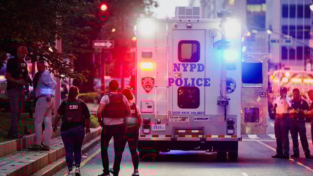 FBI agents investigate near a NYPD response vehicle near the scene of a reported shooter situation in Manhattan on July 28, 2025.