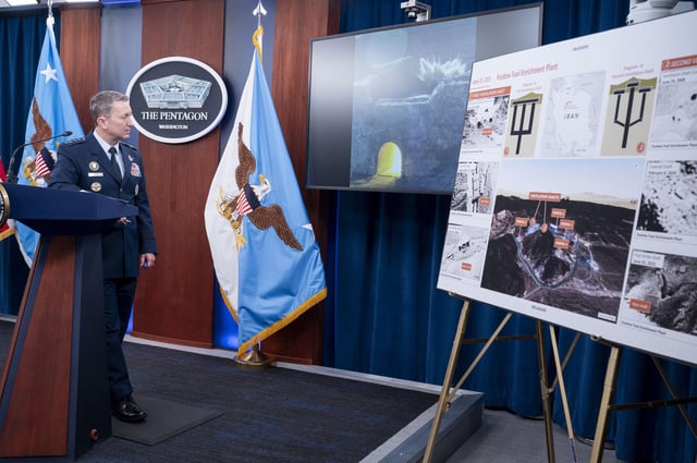 Joint Chiefs Chairman Gen. Dan Caine watches a test video of the ordinance used in the attack on the Iranian Fordow Fuel Enrichment Plant during a news conference at the Pentagon, Thursday, June 26, 2025 in Washington.