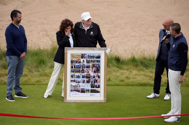 U.S. President Donald Trump and Trump International Scotland, Executive Vice President Sarah Malone pose for a picture during the the opening ceremony for Trump International Golf Links near Aberdeen, Scotland, Britain July 29, 2025.  Alastair Grant/Pool via REUTERS