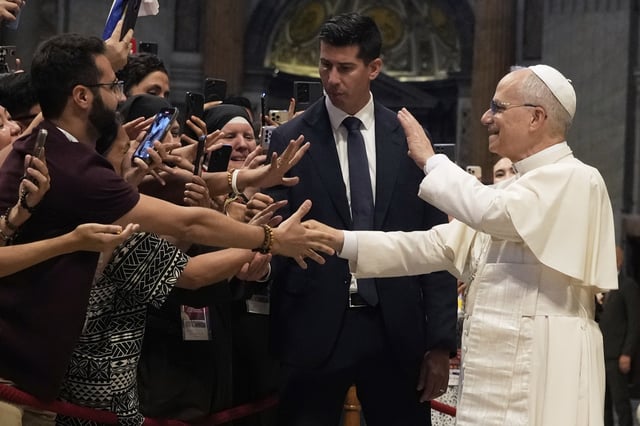 Pope Leo XIV greets faithful at the end of a mass celebrated by Cardinal Luis Antonio Tagle in St. Peter's Basilica on the occasion of the Youth Jubilee at the Vatican, Tuesday, July 29, 2025. (AP Photo/Gregorio Borgia)