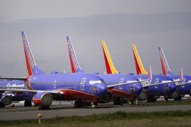 FILE - A line of Southwest Air Boeing 737 jets are parked near the company's production plant while being stored at Paine Field Friday, April 23, 2021, in Everett, Wash. (AP Photo/Elaine Thompson, File)