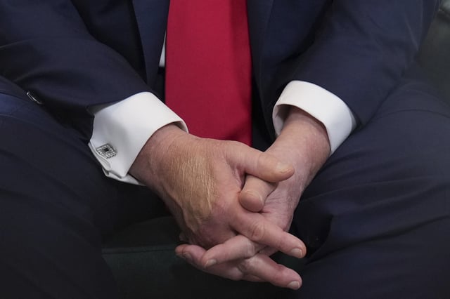 President Donald Trump clasps his hands as he speaks with the media during a meeting with Britain&#39;s Prime Minister Keir Starmer at the Trump Turnberry golf course in Turnberry, Scotland Monday, July 28, 2025.