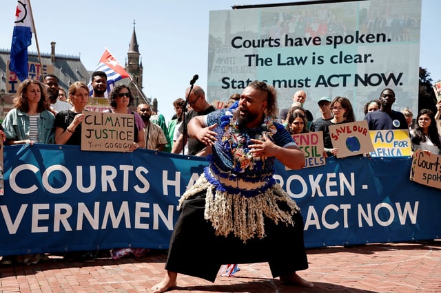 Climate activists and campaigners demonstrate outside the International Court of Justice (ICJ) ahead of the reading of an advisory opinion that is likely to determine the course of future climate action across the world, The Hague, Netherlands, July 23, 2025. REUTERS/Marta Fiorin/File Photo