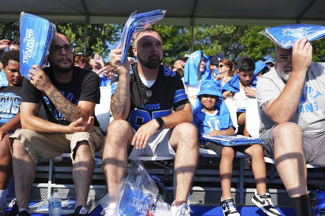 Fans watch the Detroit Lions during an NFL football practice Monday, July 28, 2025, in Allen Park, Mich.