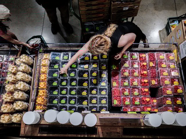 People shop for groceries at a store in New York City, U.S., July 15, 2025. REUTERS/Jeenah Moon/File Photo