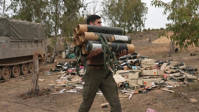An Israeli soldier carries mortar shell cases in southern Israel, near Gaza, on Nov. 25, 2023. Tax and shipping records appear to say Canadian companies have continued to ship ammunition and other materiel to Israel despite Ottawa's claims to the contrary. 