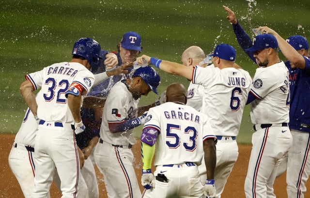 ARLINGTON, TX - JULY 26: Marcus Semien #2 of the Texas Rangers celebrates with teammates following the team&#39;s tenth inning win against the Atlanta Braves at Globe Life Field on July 26, 2025 in Arlington, Texas.