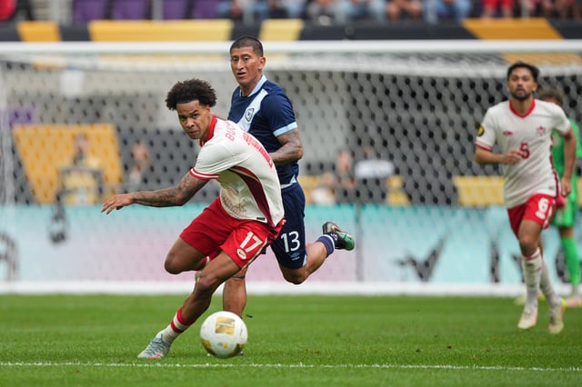 Jun 29, 2025; Minneapolis, Minnesota, USA; Canada forward Tajon Buchanan (17) and Guatemala defender Stheven Robles (13) battle for the ball in the second half during a quarterfinal match of the 2025 Gold Cup at U.S. Bank Stadium. Mandatory Credit: Brad Rempel-Imagn Images/ File Photo