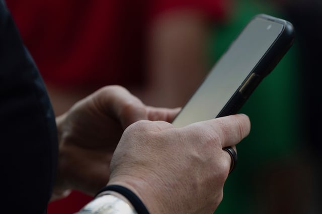A person looks at their phone at Seattle–Tacoma International Airport on Sunday, June 1, 2025, in Seattle.