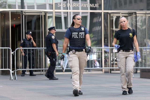 NYPD Crime Scene Unit investigators walk at the scene of a deadly mass shooting in Manhattan, New York City, U.S. July 29, 2025. REUTERS/Kylie Cooper