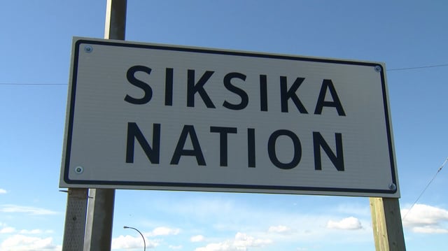 A 27-year-old resident of the Siksika Nation has been charged with two counts of first degree murder following a fatal hit and run on Saturday.