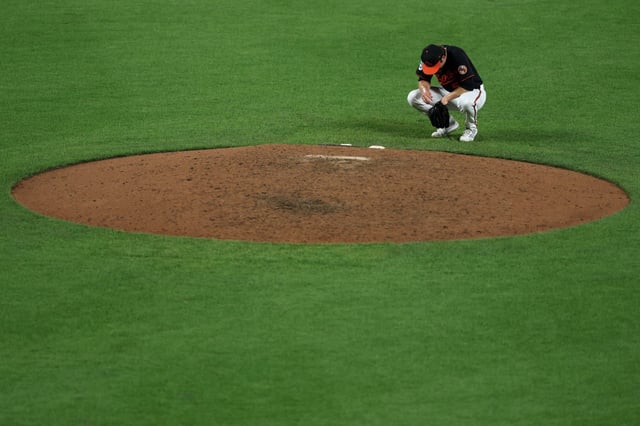 Pitcher Kade Strowd #57 of the Baltimore Orioles reacts after hitting George Springer #4 of the Toronto Blue Jays (not pictured) with a pitch in the helmet during the ninth inning at Oriole Park at Camden Yards on July 28, 2025 in Baltimore, Maryland. (Photo by Patrick Smith/Getty Images)