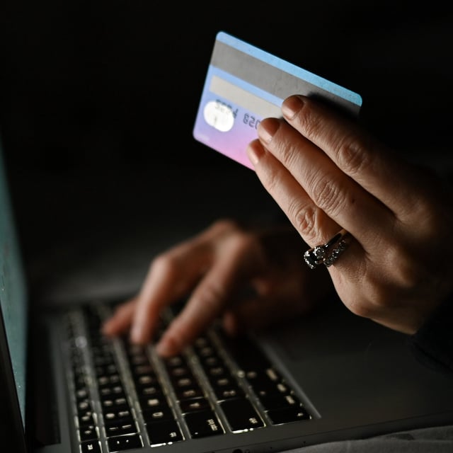 An illustrative image of a person holding a credit card while shopping on-line on a computer, in an apartment during the coronavirus pandemic. On Tuesday, January 11, 2021, in Edmonton, Alberta, Canada. (Photo by Artur Widak/NurPhoto via Getty Images)