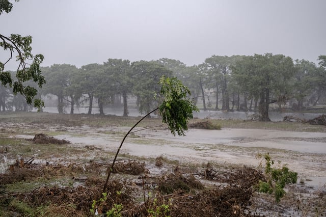 Severe thunderstorms prompt emergency flash flood warnings on the bank of the Guadalupe River during a search and recovery mission on July 13, 2025 in Kerrville, Texas.