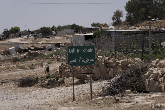 FILE - Caravans and simple structures for residents of the West Bank Bedouin village of Umm al-Khair, are seen at the entrance on July 10, 2024. (AP Photo/Maya Alleruzzo, File)