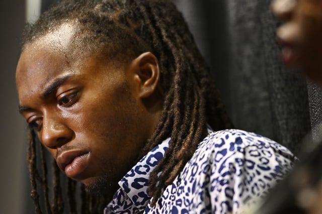 William McNeil Jr. looks on while standing next to his mother Latoya Solomon during a press conference Tuesday, July 29, 2025, in Chicago. (AP Photo/Paul Beaty)