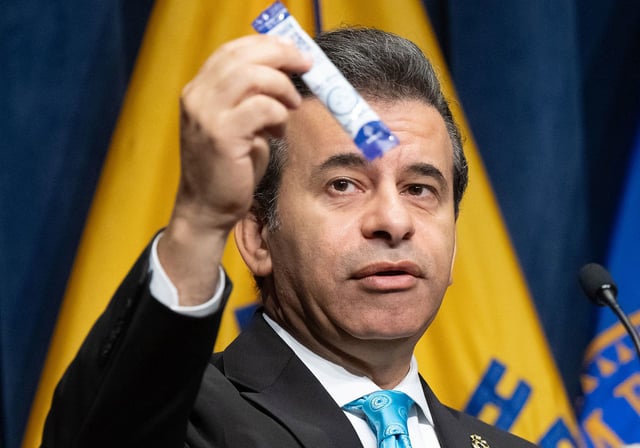 Food and Drug Administration (FDA) Commissioner Dr. Marty Makary holds up an example of a 7-OH product as he speaks about the sending of warning letters to companies for illegally marketing products containing 7-hydroxymitragynine, also known as 7-OH, as part of their actions combatting opioids, during a press conference at HHS Headquarters in Washington, DC, July 29, 2025. (Photo by SAUL LOEB / AFP) (Photo by SAUL LOEB/AFP via Getty Images)          