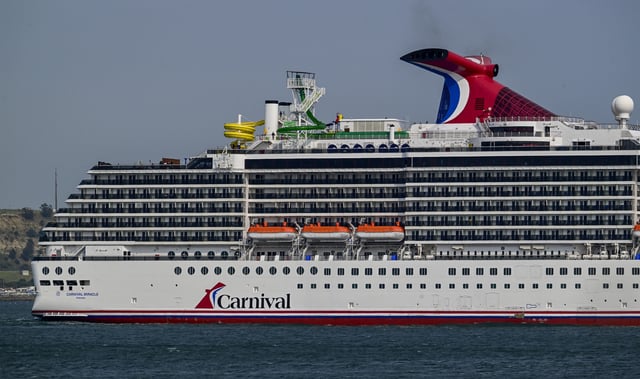 Carnival Miracle, a 88,500 GT Spirit-class cruise ship operated by Carnival Cruise Line, sails the Tagus River after departure from the cruise terminal on June 03, 2025, in Lisbon, Portugal.