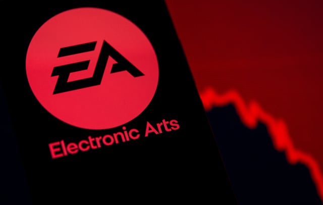 A smartphone with the Electronic Arts logo is seen in front of a displayed stock graph in this illustration taken September 16, 2021. REUTERS/Dado Ruvic/Illustration/File Photo