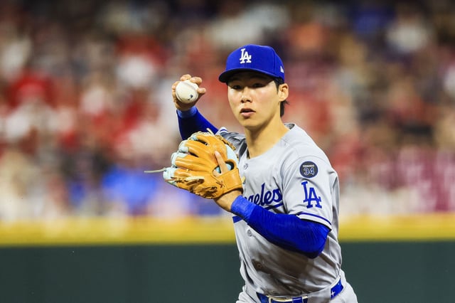 Jul 28, 2025; Cincinnati, Ohio, USA; Los Angeles Dodgers second baseman Hyeseong Kim (6) throws to first to get Cincinnati Reds outfielder TJ Friedl (not pictured) out in the eighth inning at Great American Ball Park. Mandatory Credit: Katie Stratman-Imagn Images/File Photo