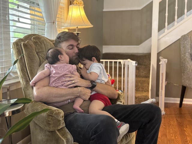 FILE - U.S. Marine Corps veteran Adrian Clouatre holds his 3-month-old daughter Lyn and his nearly two old son Noah at their home in Baton Rouge, La., June 17, 2025. (AP Photo/Stephen Smith, File)
