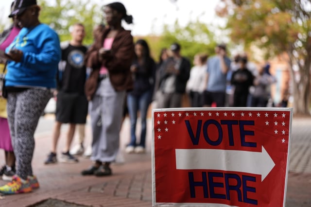 FILE - People stand in line during the last day of early voting, Saturday, Nov. 2, 2024, in Charlotte, N.C. (AP Photo/Mike Stewart, file)