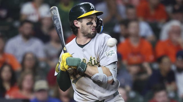 Jul 25, 2025; Houston, Texas, USA; Athletics shortstop Jacob Wilson (5) reacts to an inside pitch during the sixth inning against the Houston Astros at Daikin Park. Mandatory Credit: Troy Taormina-Imagn Images