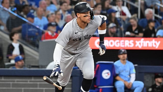 Jul 23, 2025; Toronto, Ontario, CAN; New York Yankees designated hitter Aaron Judge (99) hits a two run home run against the Toronto Blue Jays in the sixth inning at Rogers Centre. Mandatory Credit: Dan Hamilton-Imagn Images