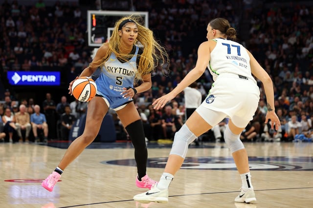 Angel Reese #5 of the Chicago Sky dribbles the ball against Maria Kliundikova #77 of the Minnesota Lynx in the first quarter at Target Center on July 22, 2025 in Minneapolis, Minnesota. The Lynx defeated the Sky 91-68.