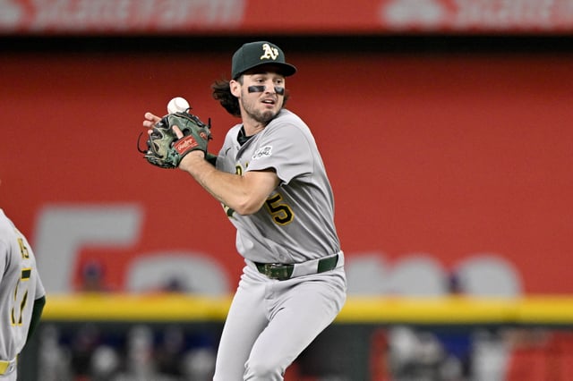 Jul 23, 2025; Arlington, Texas, USA; Athletics shortstop Jacob Wilson (5) misplays a ball hit by Texas Rangers third baseman Josh Jung (not pictured) during the second inning at Globe Life Field. Mandatory Credit: Jerome Miron-Imagn Images/File Photo