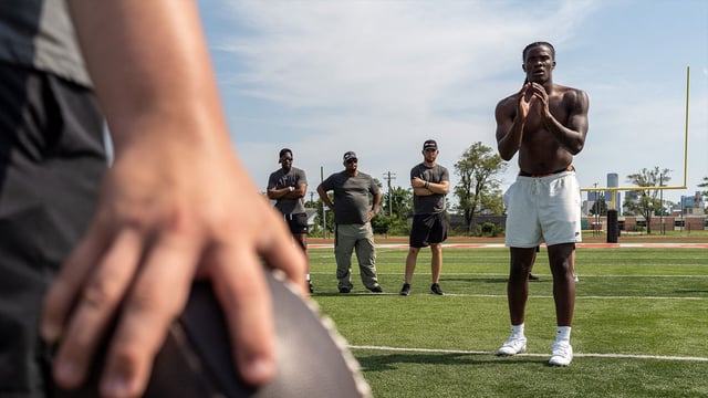 Josh Putman, 19, a member of Quarterback University, prepares to snap the ball to Bryce Underwood, 17, a freshman quarterback at the University of Michigan, during a private workout in Detroit on Saturday, June 21, 2025.