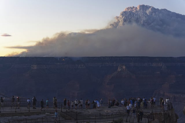 Smoke and a pyrocumulus cloud rises at sunset from the Dragon Bravo fire at the Grand Canyon as seen from Mather Point near Grand Canyon Village, Ariz., Monday, July 28, 2025. (AP Photo/Jon Gambrell)