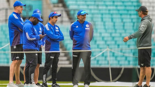 London: India's head coach Gautam Gambhir and support staff interact with a groundsman during a training session